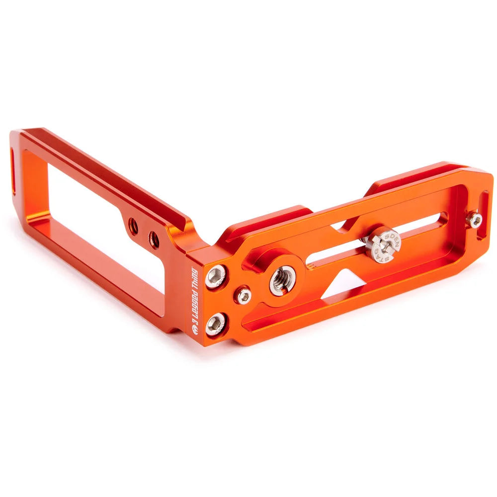 3-Legged-Thing QR11 FBC-2 universal L-bracket in orange, Arca-Swiss compatible with adjustable vertical and horizontal mounting via quick-release clamp.