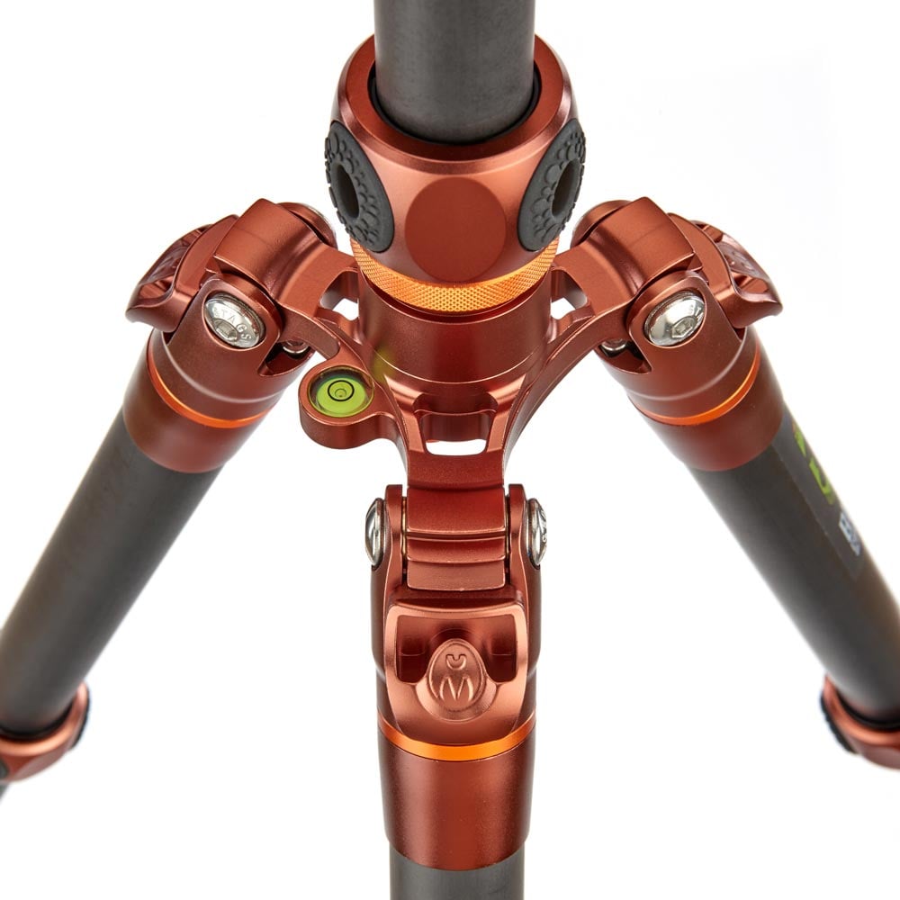 Close-up of a red and black tripod on a white background