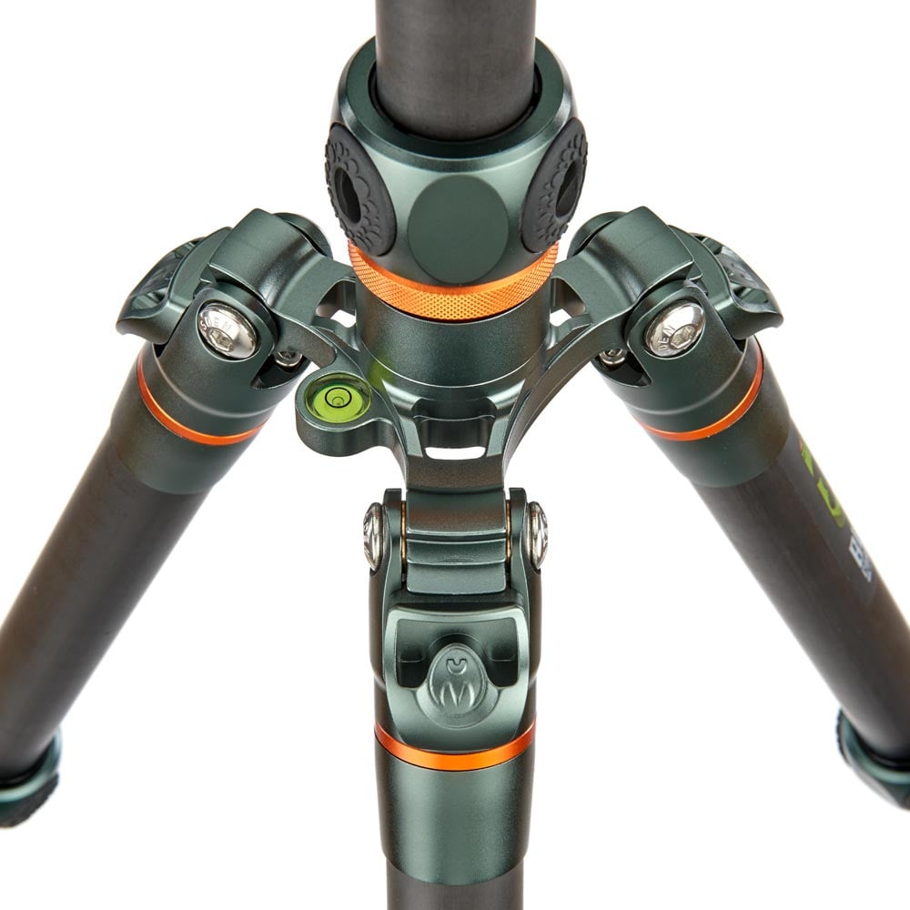 Close-up of a camera tripod with green and black color scheme on a white background