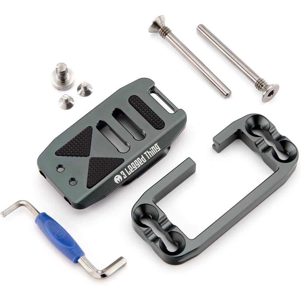 Camera accessory kit with gray metal bracket, screws, and blue tool on a white background
