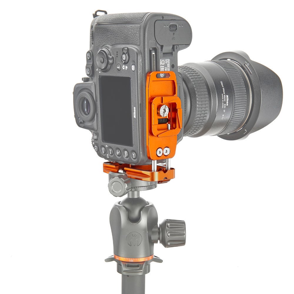 Camera with an orange quick release plate on a white background