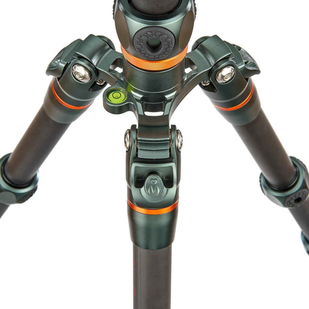 Close-up of a green and black tripod with orange accents on a white background