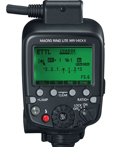 Black camera flash controller with digital display on a white background