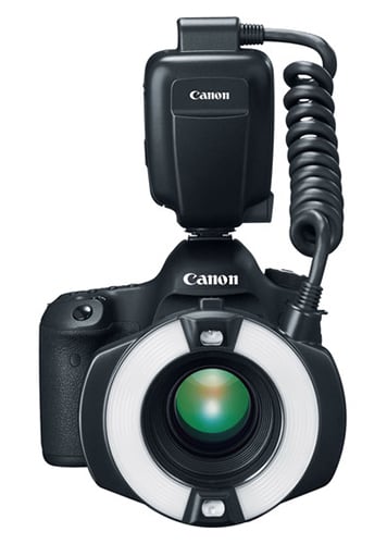 Canon camera with ring light and flash on a white background