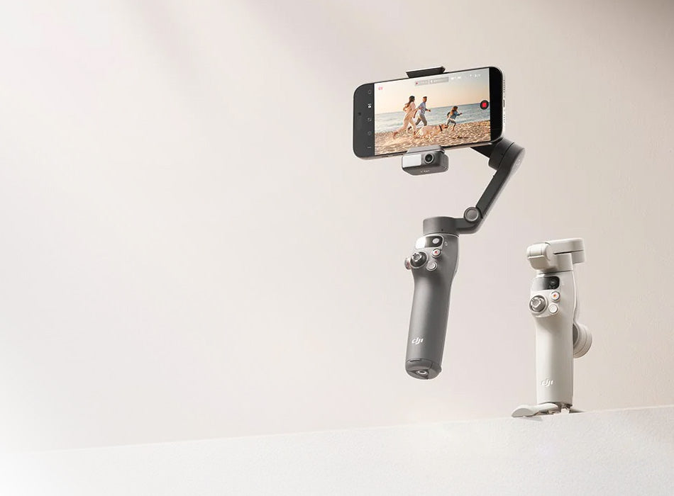Handheld camera stabilizer with smartphone attached on a light background