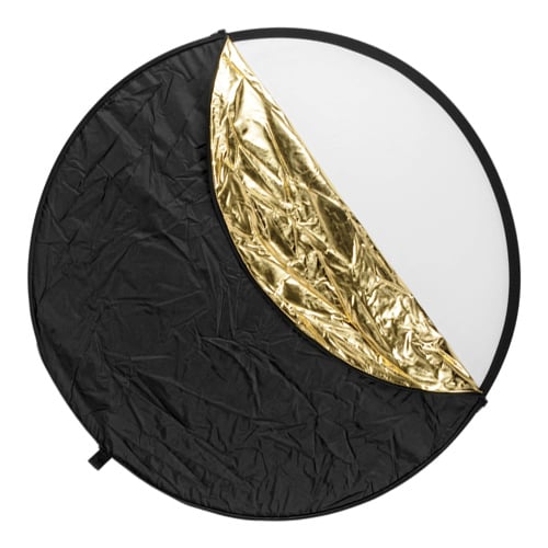 Round photography reflector with black, gold, and white sections on a white background