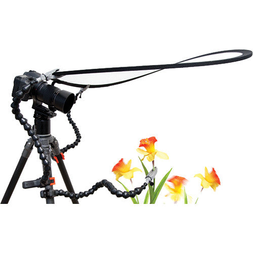 Wimberley The Plamp II articulated Loc-Line arm clamp attached to a tripod leg, holding a small object with foam-padded jaws for precise positioning in photography.