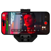 Atomos Ninja Phone video co-processor — compact black module with locking cable connector, metal housing, and HDMI/USB-C ports for professional iPhone video workflow.