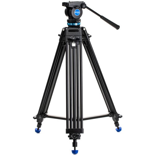Benro KH25P video tripod in black with fluid video head attached, featuring three-section adjustable legs with flip locks, integrated mid-level spreader, retractable spiked rubber feet, ergonomic fluid pan‑tilt head with control arms, quick‑release camera plate, and built-in bubble level.