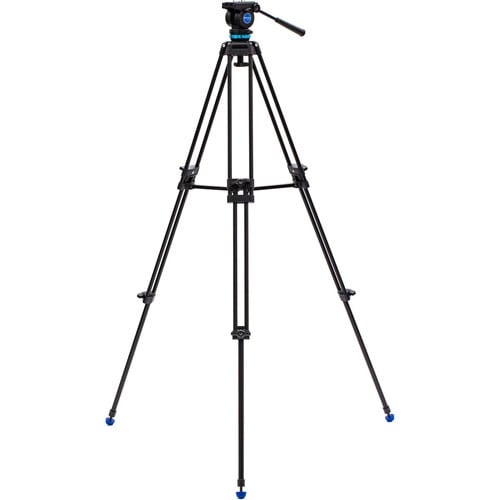 Benro KH25P video tripod in black with fluid video head attached, featuring three-section adjustable legs with flip locks, integrated mid-level spreader, retractable spiked rubber feet, ergonomic fluid pan‑tilt head with control arms, quick‑release camera plate, and built-in bubble level.