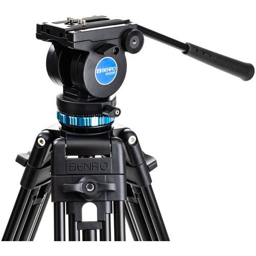 Benro KH25P video tripod in black with fluid video head attached, featuring three-section adjustable legs with flip locks, integrated mid-level spreader, retractable spiked rubber feet, ergonomic fluid pan‑tilt head with control arms, quick‑release camera plate, and built-in bubble level.