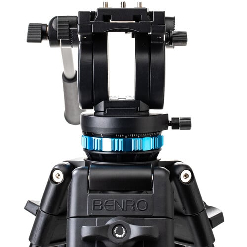 Benro KH25P video tripod in black with fluid video head attached, featuring three-section adjustable legs with flip locks, integrated mid-level spreader, retractable spiked rubber feet, ergonomic fluid pan‑tilt head with control arms, quick‑release camera plate, and built-in bubble level.