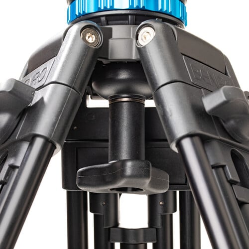 Benro KH25P video tripod in black with fluid video head attached, featuring three-section adjustable legs with flip locks, integrated mid-level spreader, retractable spiked rubber feet, ergonomic fluid pan‑tilt head with control arms, quick‑release camera plate, and built-in bubble level.