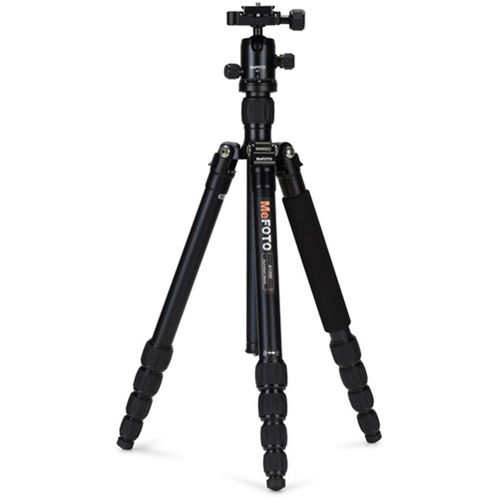 MeFoto RoadTrip aluminium tripod with reverse-folding legs, extending to 156.5 cm, supporting up to 8 kg, and converting into a full-size monopod via a removable foam-cushioned leg. Features two-position leg angle stops, spring-loaded centre column hook, Arca-type quick release plate, double action ball head with 360° pan, and included carry case.