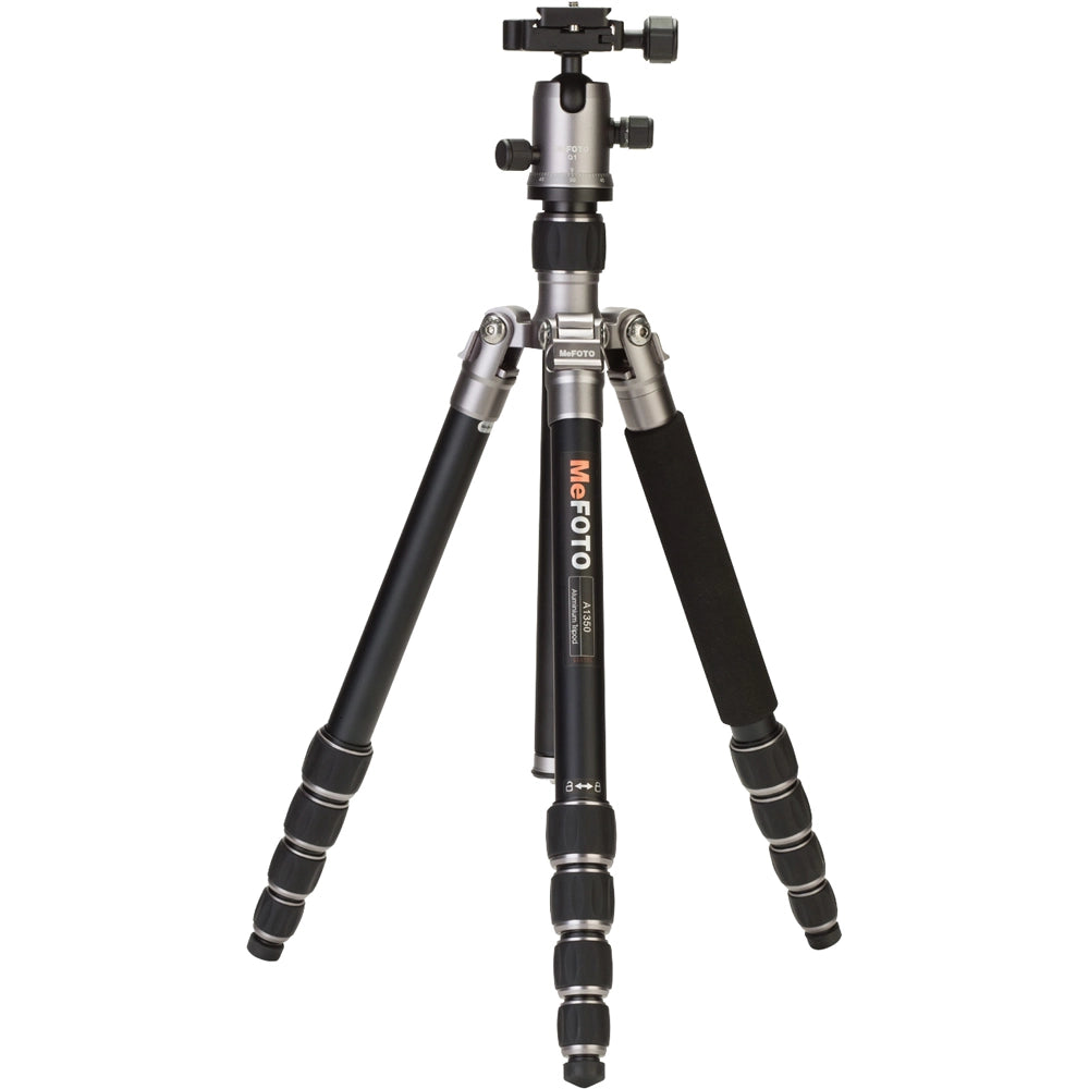 MeFoto RoadTrip aluminium tripod with reverse-folding legs, extending to 156.5 cm, supporting up to 8 kg, and converting into a full-size monopod via a removable foam-cushioned leg. Features two-position leg angle stops, spring-loaded centre column hook, Arca-type quick release plate, double action ball head with 360° pan, and included carry case.
