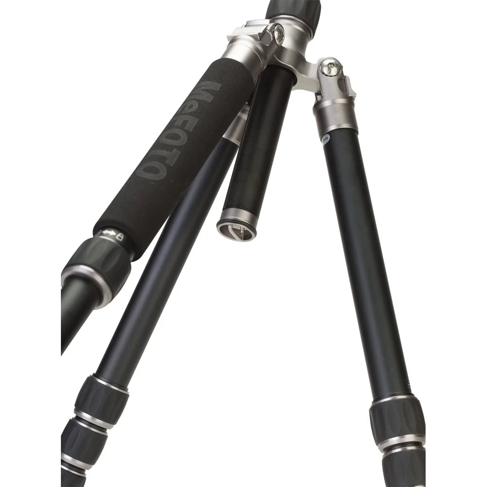 MeFoto RoadTrip aluminium tripod with reverse-folding legs, extending to 156.5 cm, supporting up to 8 kg, and converting into a full-size monopod via a removable foam-cushioned leg. Features two-position leg angle stops, spring-loaded centre column hook, Arca-type quick release plate, double action ball head with 360° pan, and included carry case.