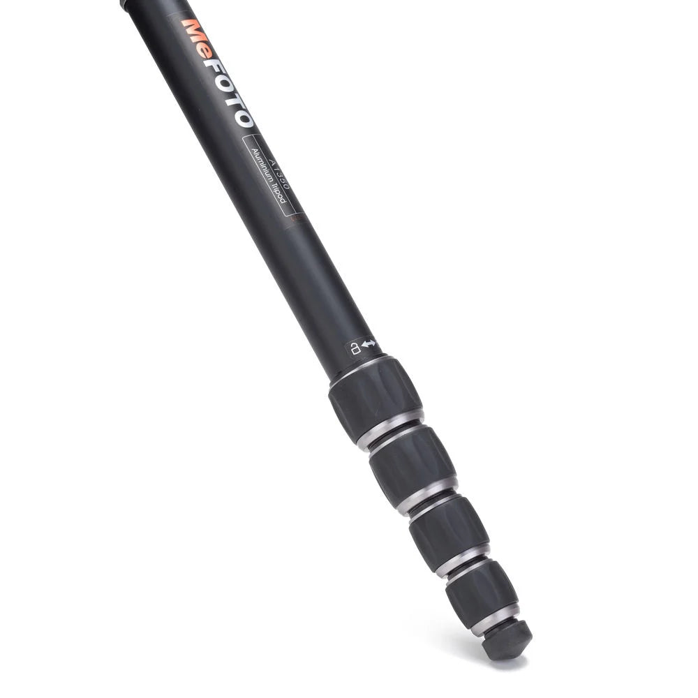 MeFoto RoadTrip aluminium tripod with reverse-folding legs, extending to 156.5 cm, supporting up to 8 kg, and converting into a full-size monopod via a removable foam-cushioned leg. Features two-position leg angle stops, spring-loaded centre column hook, Arca-type quick release plate, double action ball head with 360° pan, and included carry case.
