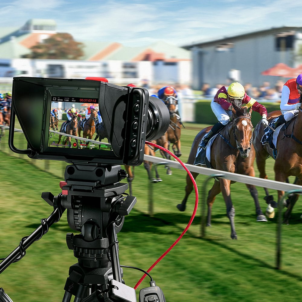 Blackmagic Design Studio Camera 4K Plus G2 with MFT lens mount, 4K UHD 3840x2160 sensor, 25,600 ISO, 12G-SDI and HDMI outputs, 7" LCD viewfinder with sunshade, Blackmagic RAW recording, and built-in DaVinci Resolve colour correction.