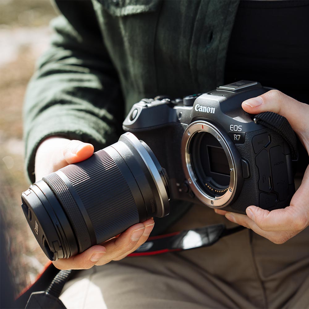 Canon EOS R7 Mirrorless Camera + RF-S 18-150mm Lens: 32.5MP APS-C sensor, DIGIC X processor, 4K 60p video (7K oversampled), 30fps burst, 7-stop IBIS, Dual Pixel CMOS AF II with AI tracking, RF-S 18-150mm f/3.5-6.3 IS STM lens with 4.5-stop stabilization included.
