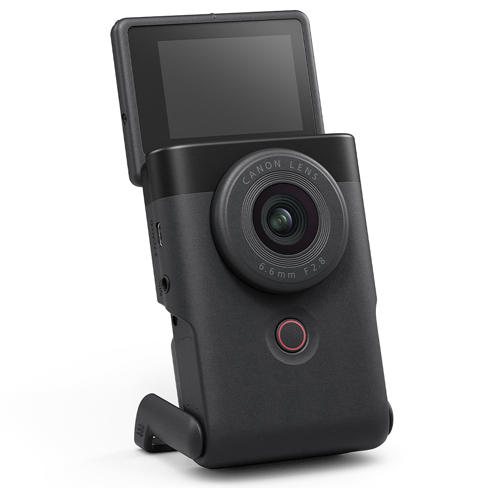 Canon PowerShot V10 Vlog Camera in black, compact rectangular body with wide-angle lens, tilting flip-up screen, and built-in stand.