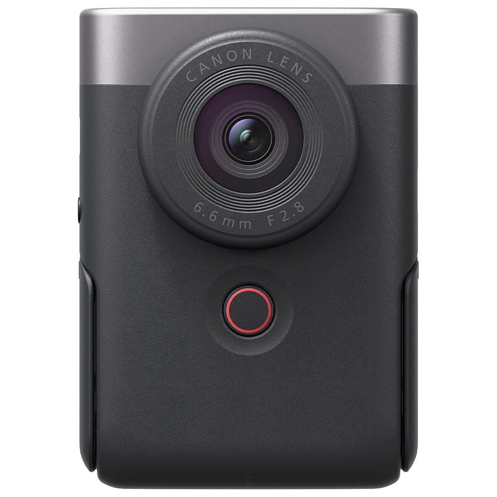 Canon PowerShot V10 vlog camera kit in silver — compact rectangular camera with wide-angle lens, flip-up screen, and integrated mini tripod stand.