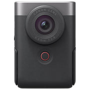 Canon PowerShot V10 vlog camera kit in silver — compact rectangular camera with wide-angle lens, flip-up screen, and integrated mini tripod stand.