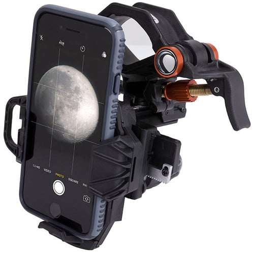 Phone with a moon image displayed on screen, held by a phone holder against a white background