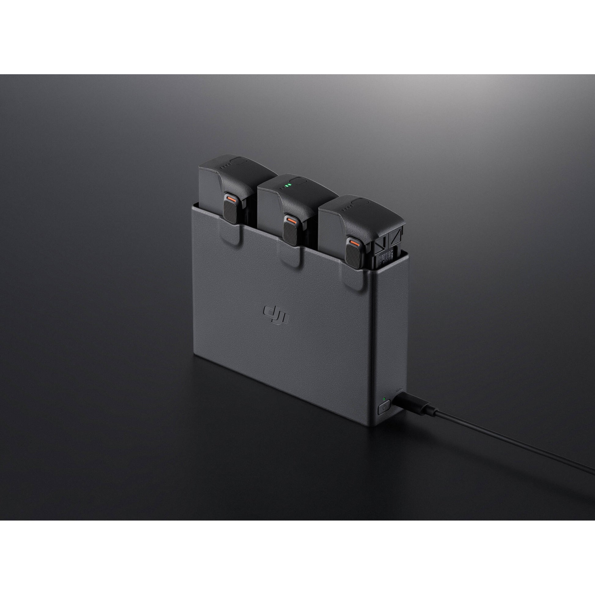 A black DJI Avata 2 Two-Way Charging Hub is shown with a USB-C cable attached.