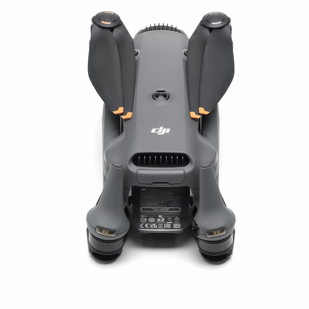 A grey DJI Mavic 4 Pro drone is shown from the front with its four arms extended and its triple-camera system visible