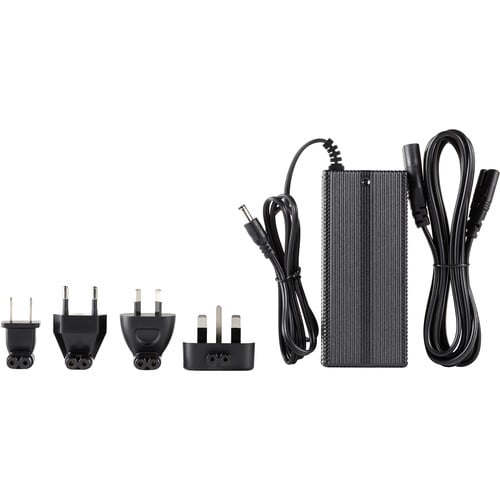 Black power adapter with multiple plug sockets on a white background