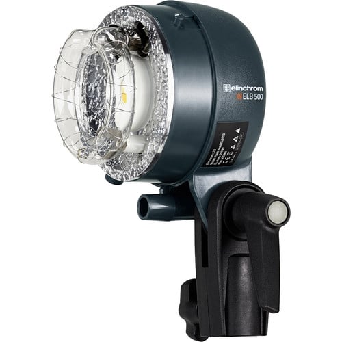 Studio light with clear lens and black housing on a white background