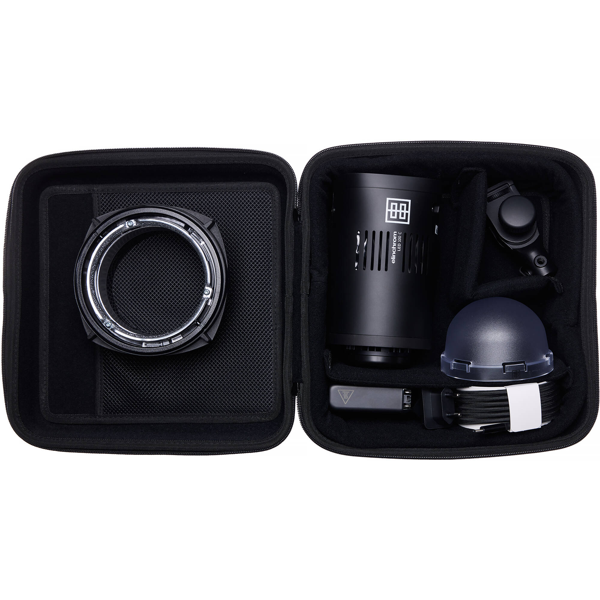 Black camera lens and accessories in a travel case on a white background