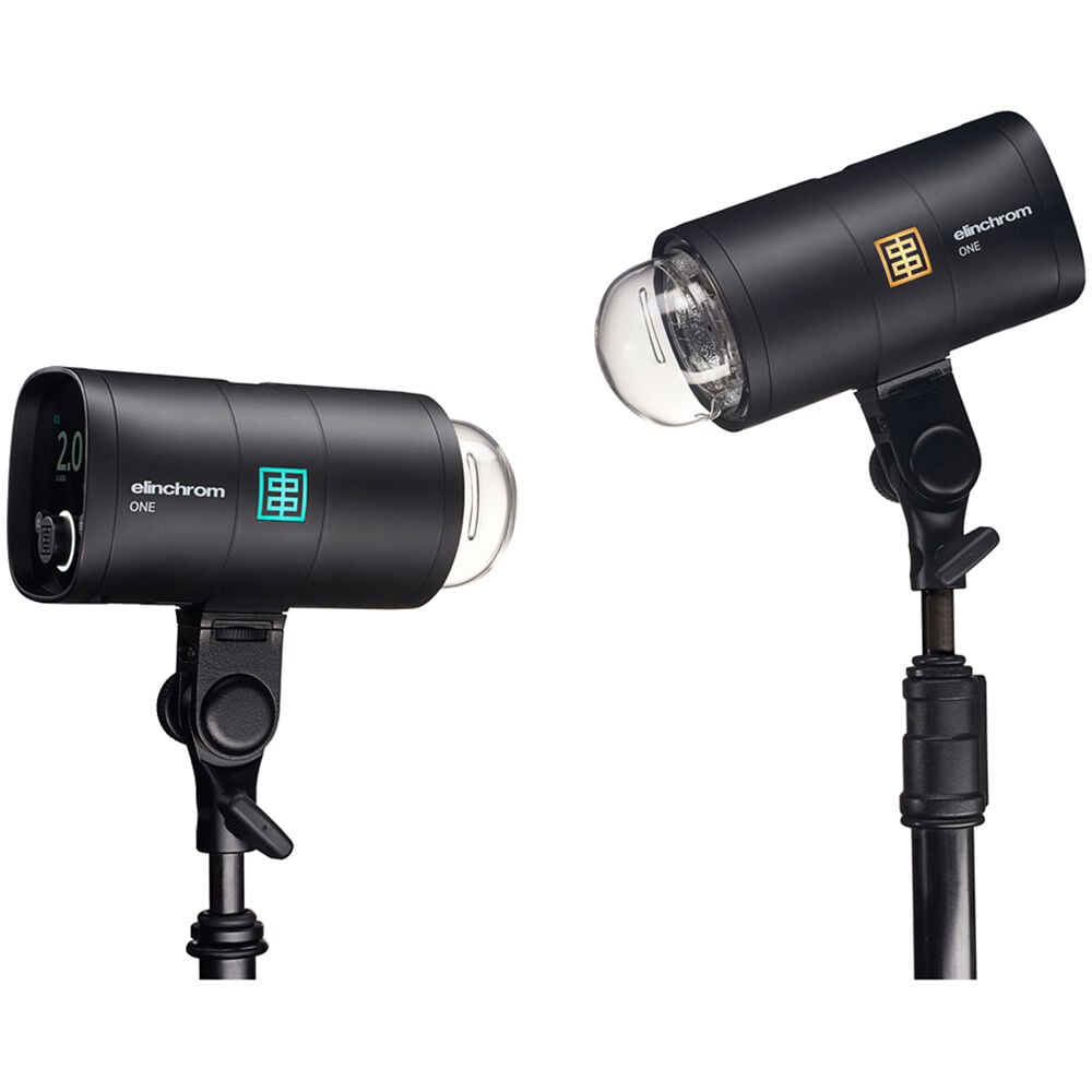 Two black studio lights with 'Elinchrom' branding on a white background