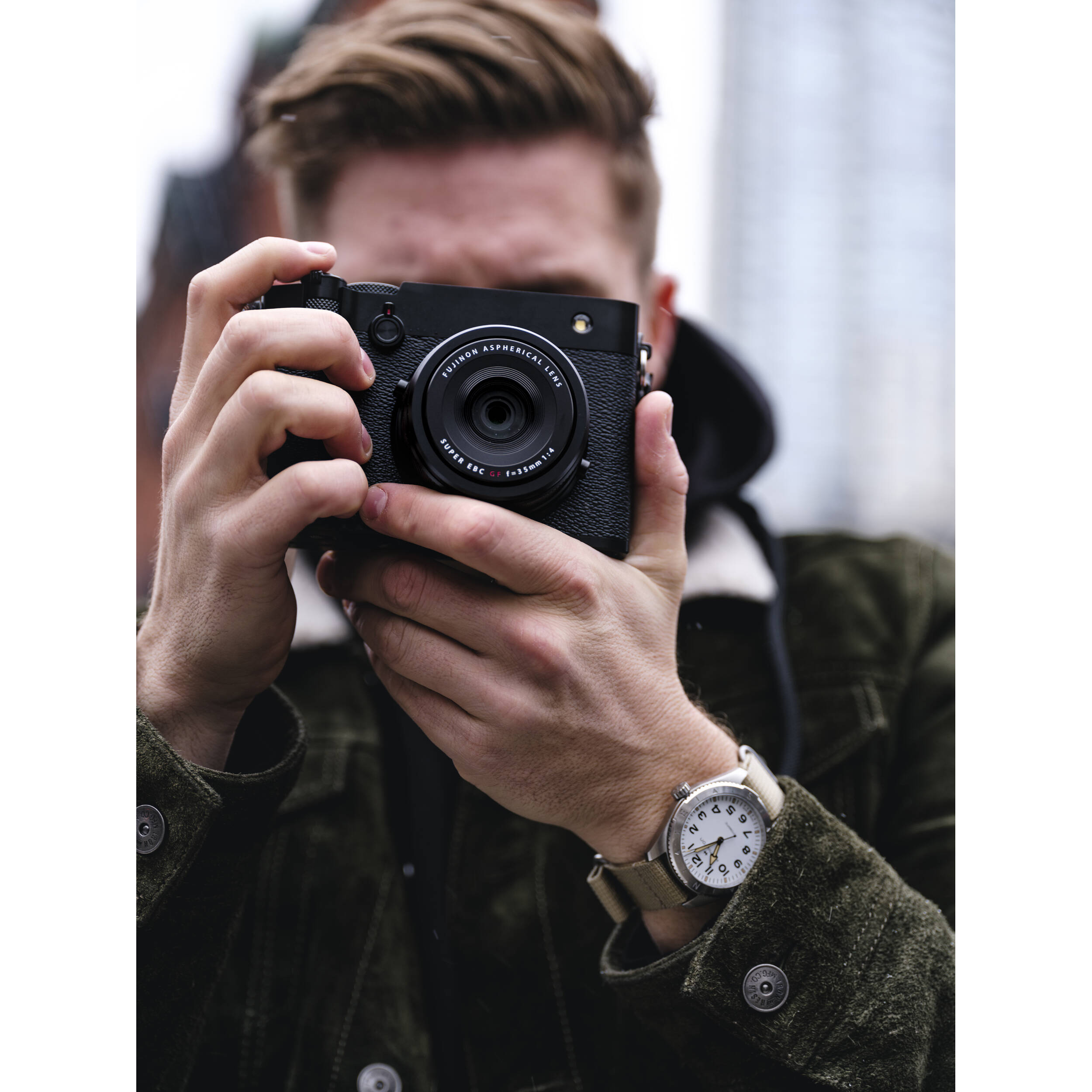 Black Fujifilm GFX 100RF digital camera featuring a compact medium format 102MP sensor, fixed 35mm f/4 lens with leaf shutter and built-in 4-stop ND filter, 3.2-inch tilting touchscreen, AI autofocus with subject detection, 4K video recording, and weather-sealed aluminum body.