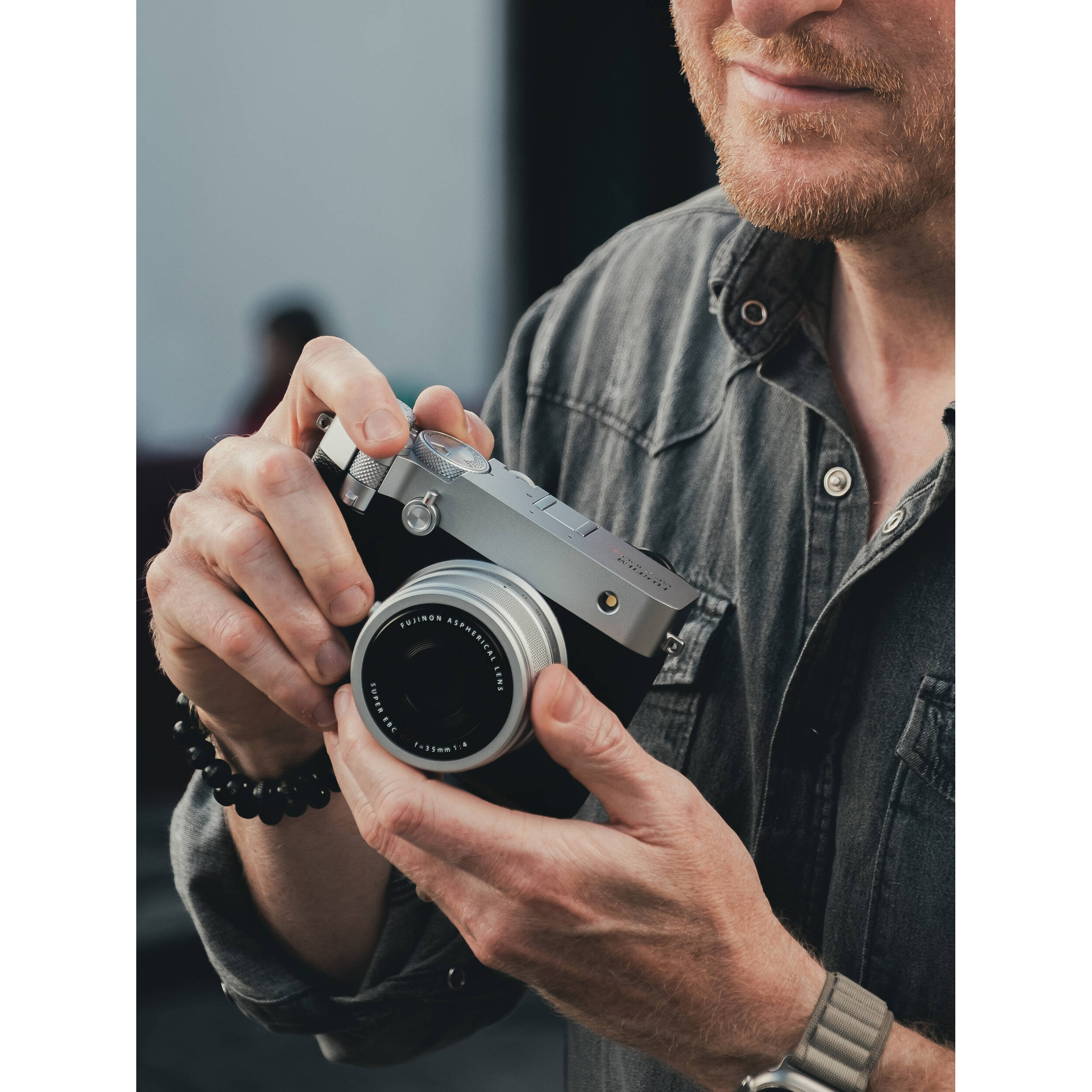 Silver Fujifilm GFX 100RF medium format digital camera with a 102MP CMOS II sensor, fixed 35mm f/4 lens with 4-stop ND filter, 3.15-inch tilting touchscreen, OLED EVF, advanced autofocus, multiple aspect ratio dial, 4K video, and lightweight aluminum body.