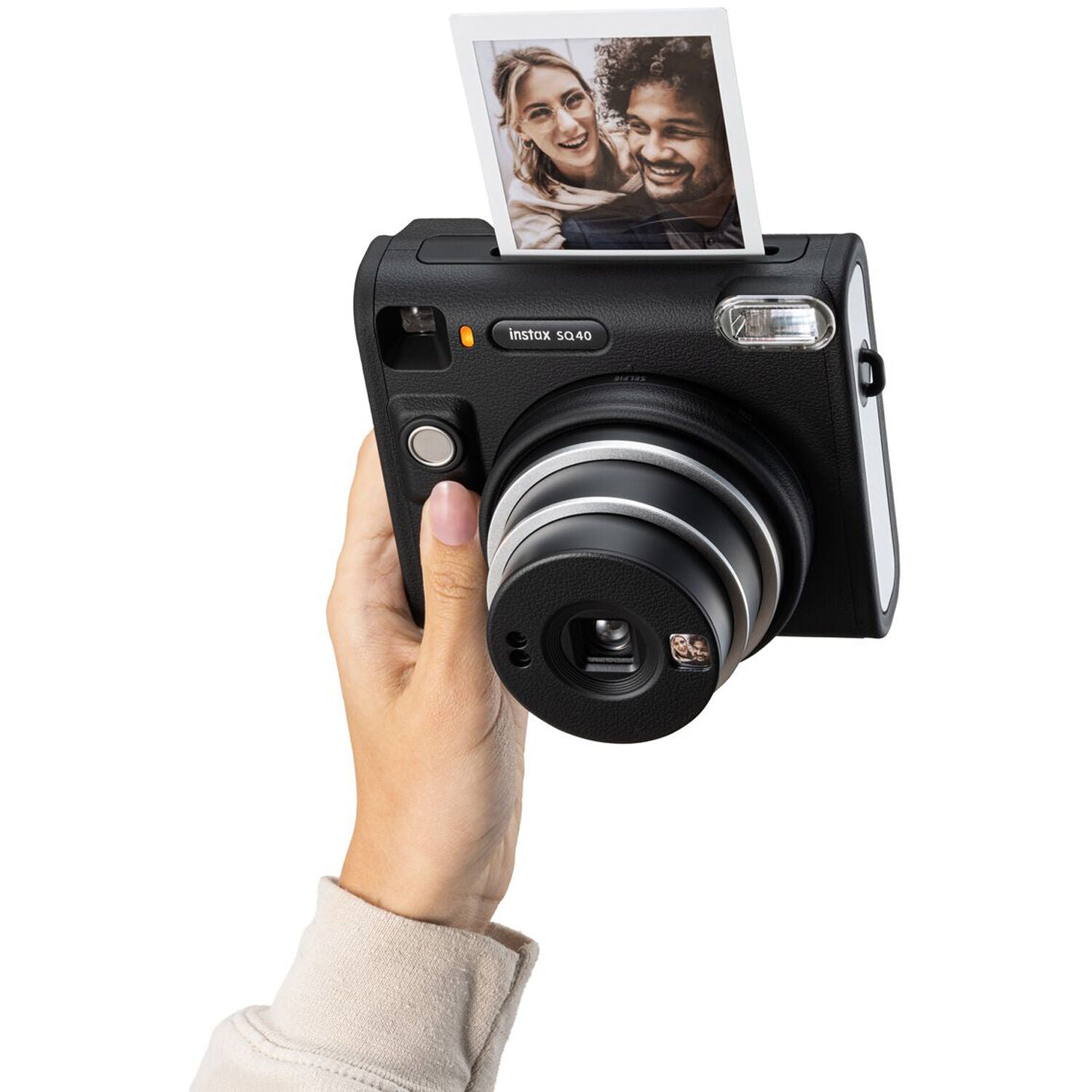 Fujifilm Instax Square SQ40 instant film camera in black, showing the square-format lens, built-in flash, selfie mirror on the lens ring, and a credit-card-sized print emerging from the top.