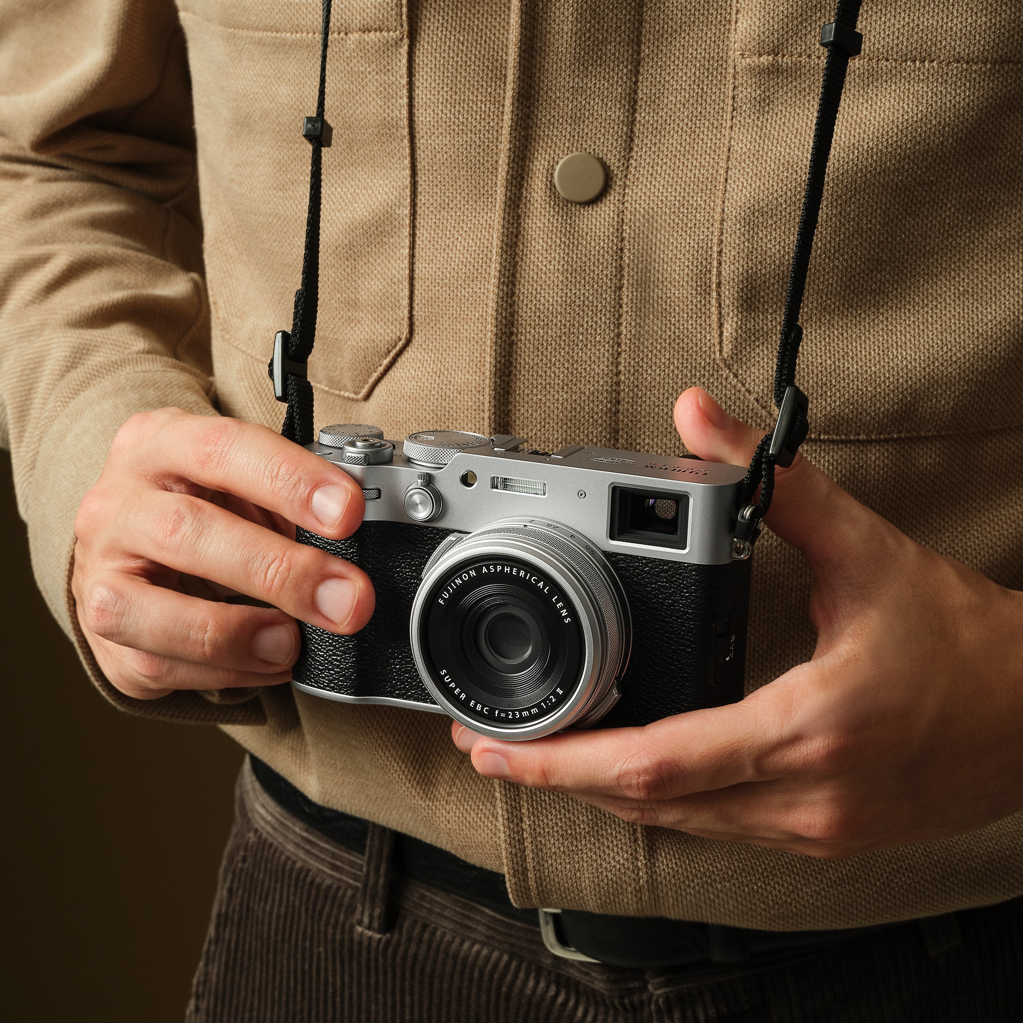 Fujifilm X100VI silver compact camera with 40.2MP APS-C X-Trans CMOS 5 HR sensor, 23mm f/2 fixed lens, 5-axis in-body image stabilization, hybrid optical/electronic viewfinder, 6.2K video recording, and 3-inch tilting touchscreen.
