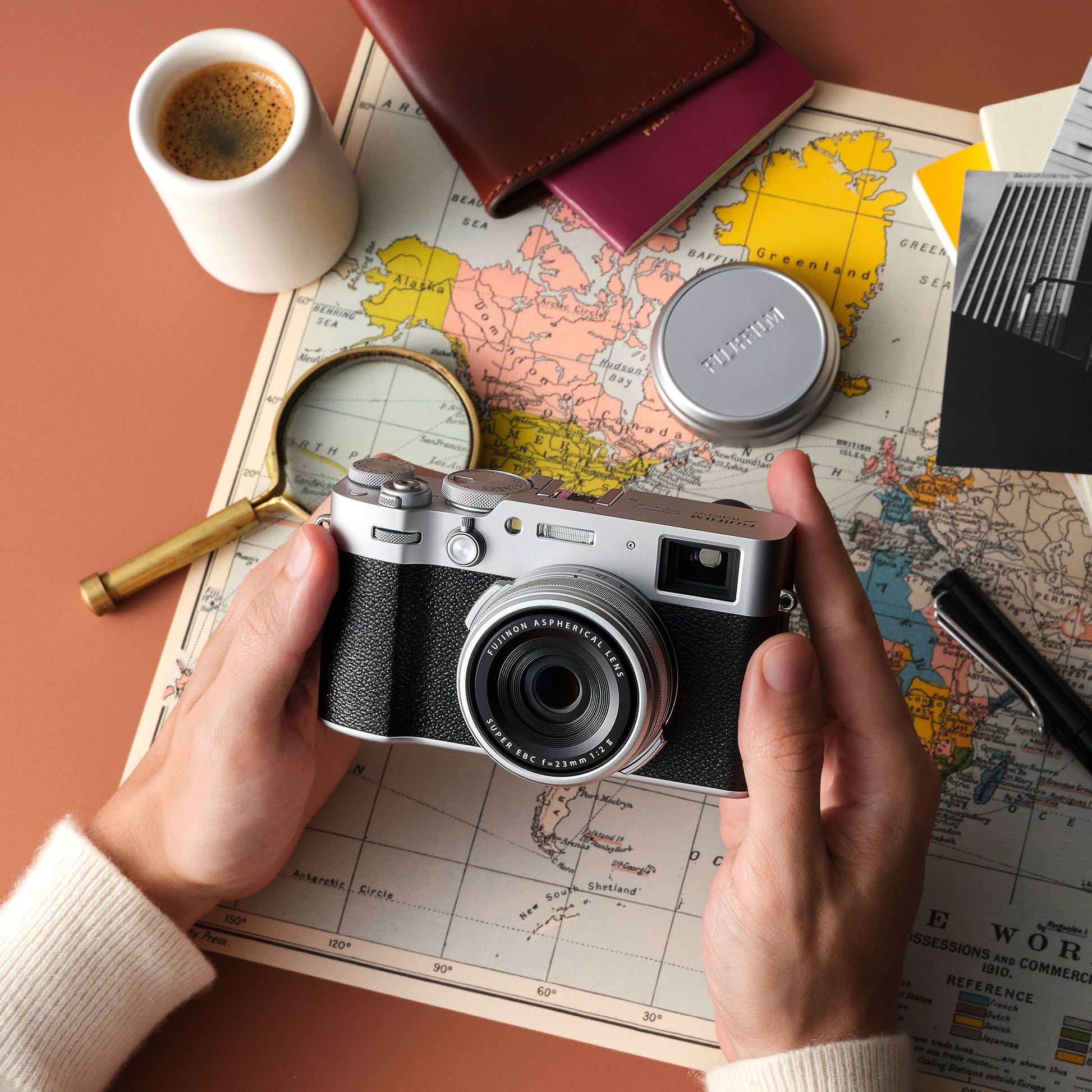 Fujifilm X100VI silver compact camera with 40.2MP APS-C X-Trans CMOS 5 HR sensor, 23mm f/2 fixed lens, 5-axis in-body image stabilization, hybrid optical/electronic viewfinder, 6.2K video recording, and 3-inch tilting touchscreen.