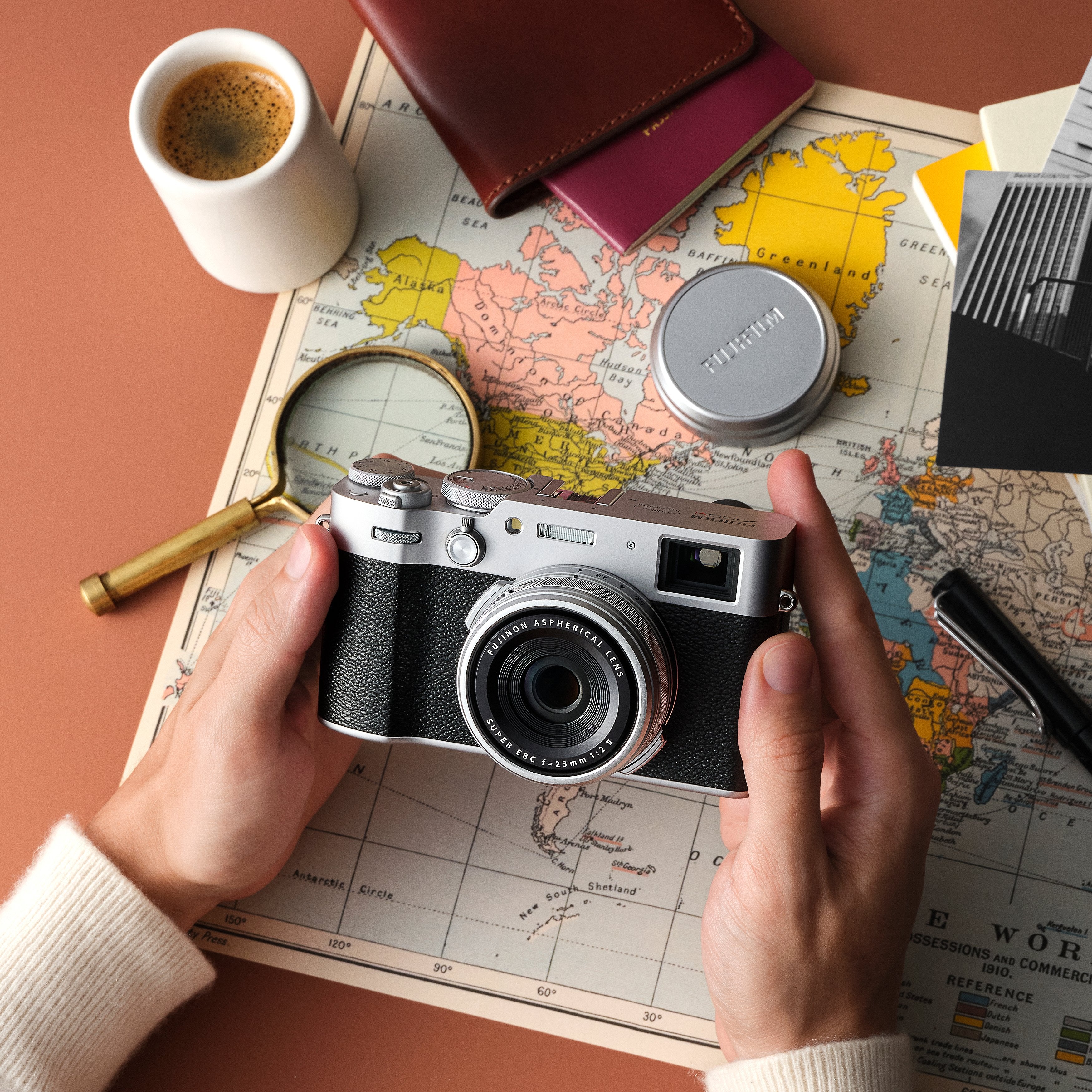 Fujifilm X100VI silver compact camera with 40.2MP APS-C X-Trans CMOS 5 HR sensor, 23mm f/2 fixed lens, 5-axis in-body image stabilization, hybrid optical/electronic viewfinder, 6.2K video recording, and 3-inch tilting touchscreen.