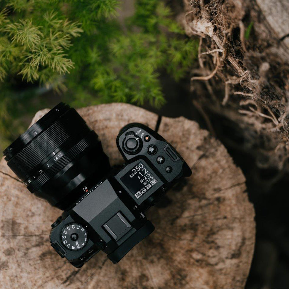 Fujifilm X‑H2 mirrorless camera body in black, featuring a robust APS‑C mount design with grip, vari-angle touchscreen, top-panel status LCD, and electronic viewfinder.