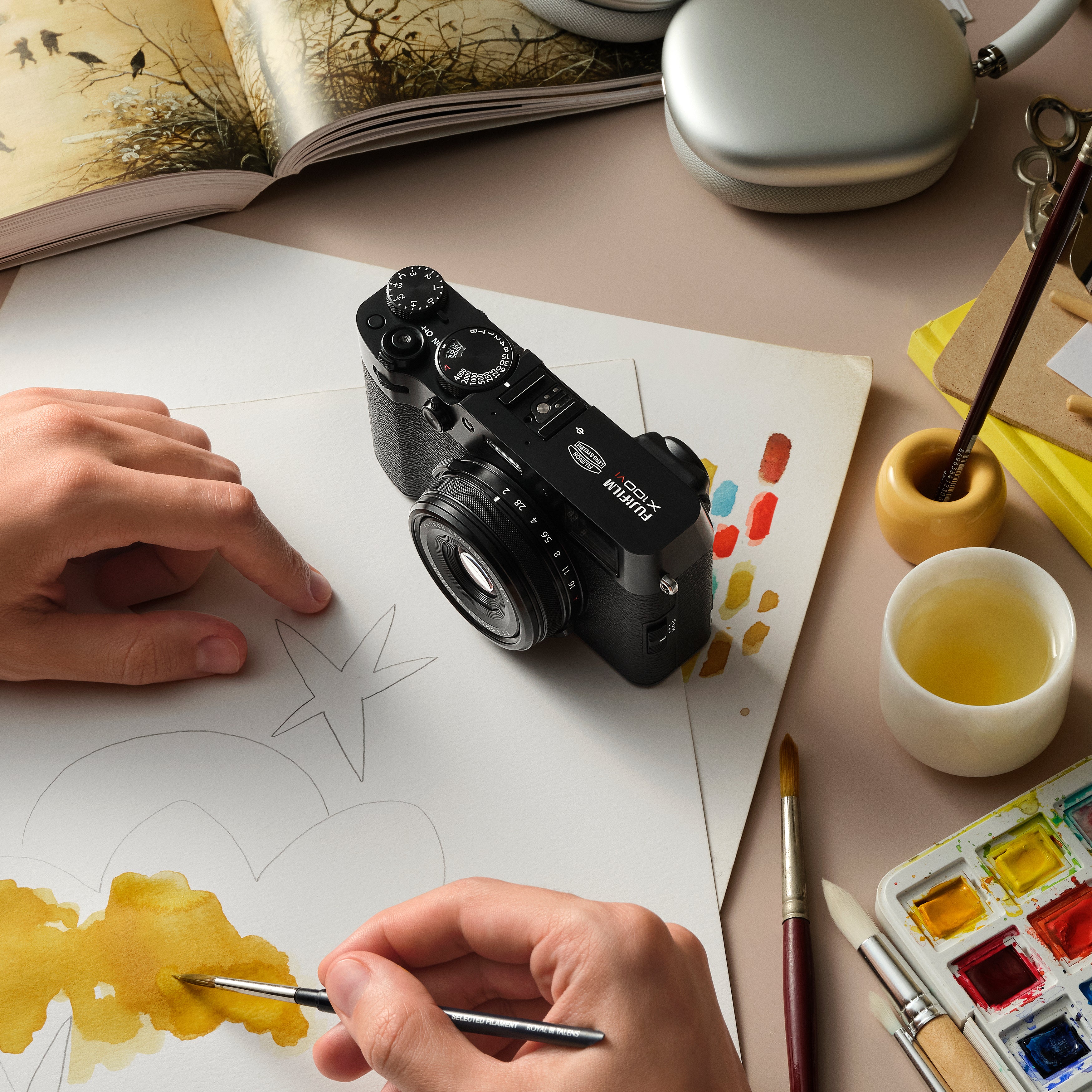 Fujifilm X100VI black compact digital camera featuring 40.2MP APS-C X-Trans CMOS 5 HR sensor, 23mm f/2 fixed lens, 5-axis in-body image stabilization, hybrid optical/electronic viewfinder, and 3-inch tilting touchscreen.