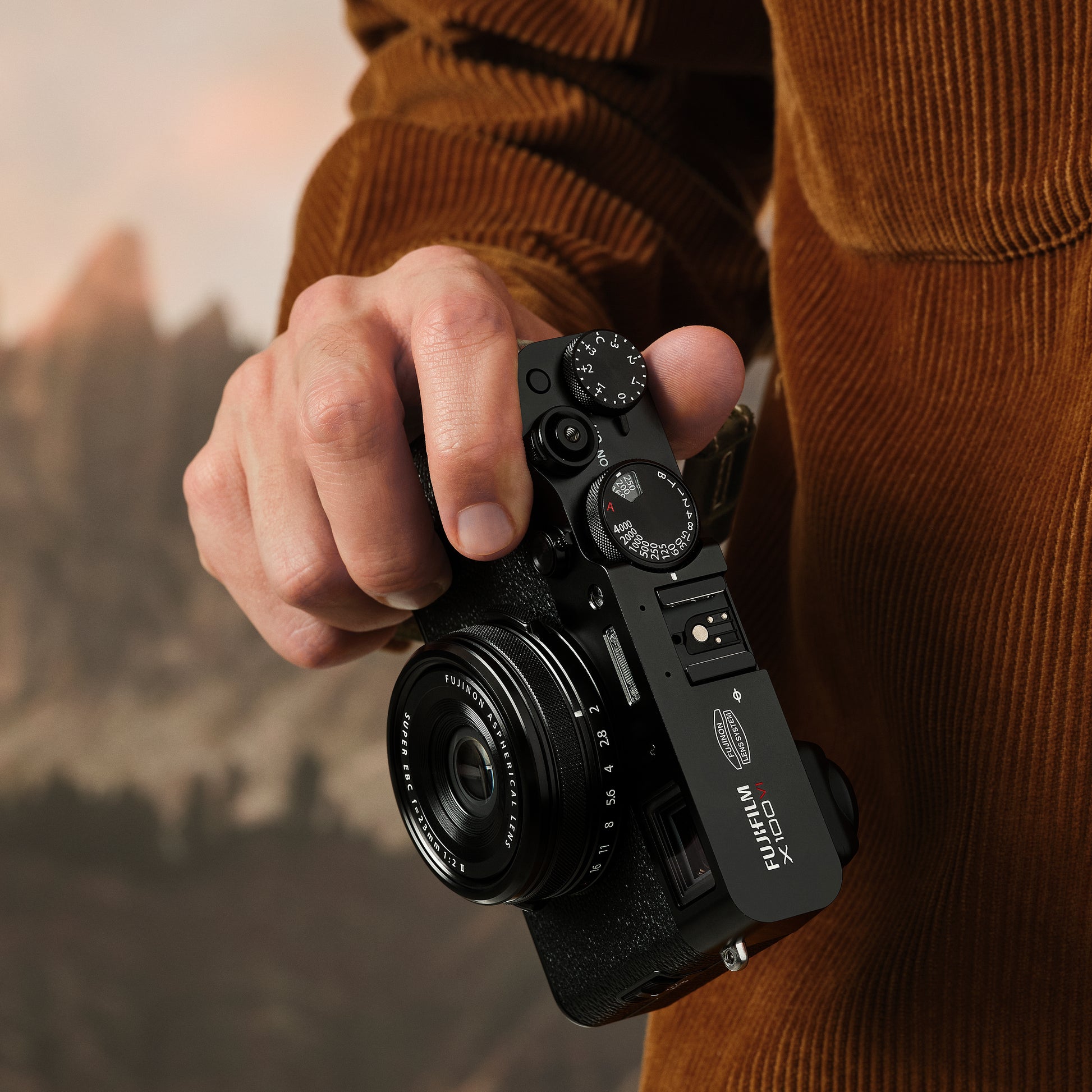 Fujifilm X100VI black compact digital camera featuring 40.2MP APS-C X-Trans CMOS 5 HR sensor, 23mm f/2 fixed lens, 5-axis in-body image stabilization, hybrid optical/electronic viewfinder, and 3-inch tilting touchscreen.