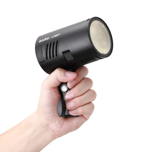 Hand holding a Godox AD100Pro flash light on a white background