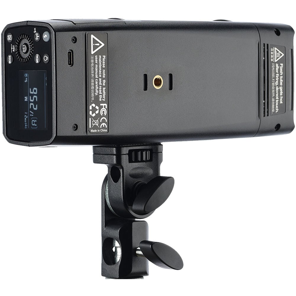 Black camera flash device with digital display on a white background