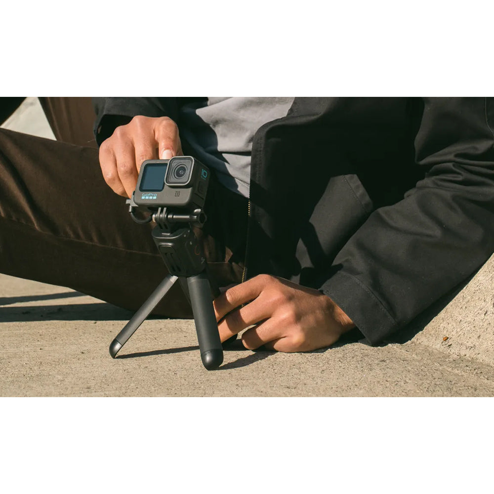 GoPro VOLTA Battery Grip + Tripod Remote in black, featuring integrated battery handle, fold-out tripod legs, built-in wireless remote, and USB-C charging port.