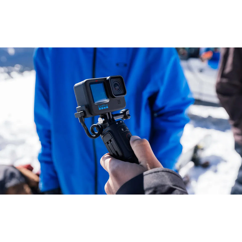 GoPro VOLTA Battery Grip + Tripod Remote in black, featuring integrated battery handle, fold-out tripod legs, built-in wireless remote, and USB-C charging port.
