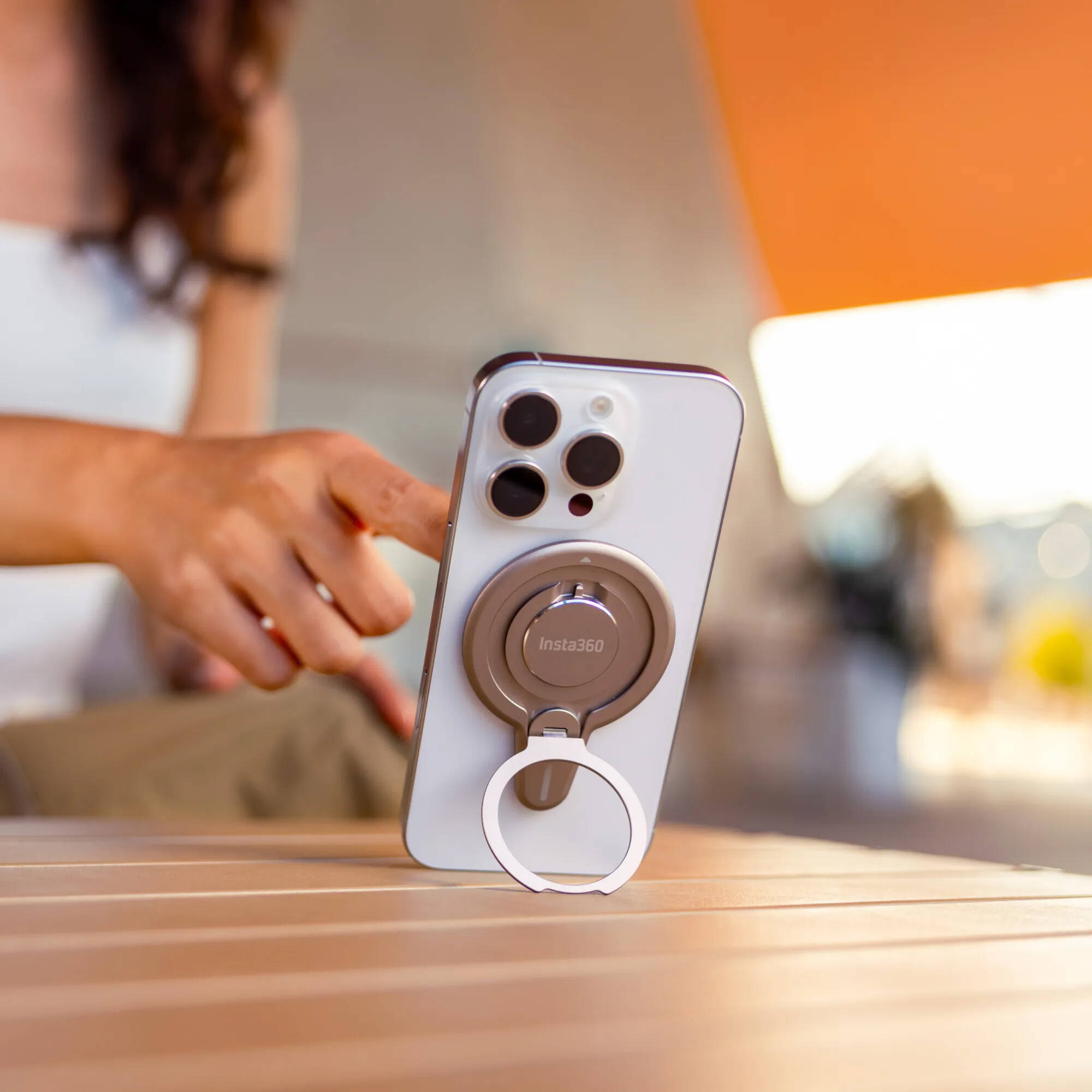 Insta360 Flow 2 Pro Magnetic Phone Mount with strong N52-grade magnets designed to securely hold MagSafe-compatible iPhone 12 or later models, featuring a 360° rotatable metal ring stand that doubles as a desktop phone stand, lightweight aluminum and silicone build, and compact 8.1 x 5.6 x 0.5 cm size.