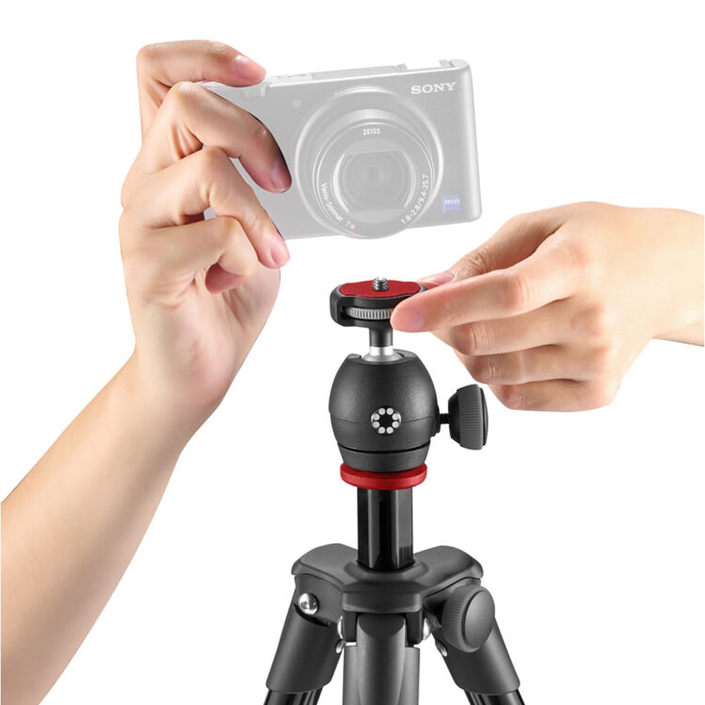 Person adjusting a camera on a tripod with a white background