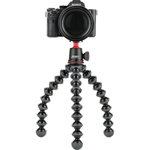 Camera on a Joby gorilla pod stand with a white background