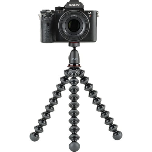 Camera mounted on a Joby gorilla pod stand with a white background